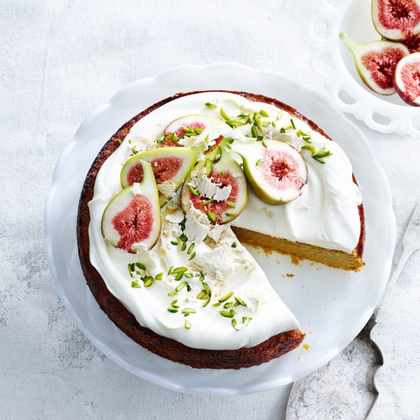 overhead-view-of-orange-and-almond-cake-with-yoghurt-cream-pistachios-figs-and-cake-server.jpg